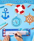 Person writing on a nameplate from the 64 Piece Nautical Classroom Decor Bundle With Nameplates And Sailing Paper Cutouts Plus Glue Dot Sheets