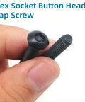 Heavy Duty M2 Screw Assortment Kit With Nuts And Washers Plus Wrench Black Zinc Plated Button Head Socket Cap Bolts hand holding hex socket cap screws.