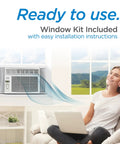 No Sweat With This White 8000 Btu Window Air Conditioner Keeping Small To Medium Rooms Chill With Four Speed Settings For Sweet Relief And Cozy Comfort Any Day Of The Year in a living room, installed and ready to use.