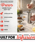 Removable infuser demonstrated brewing with spices and fruits, highlighting versatility beyond just tea in a kitchen setting.