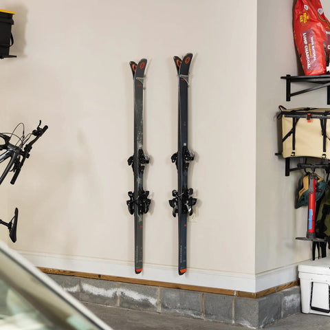 Clear Acrylic Ski Wall Mount 2 Pack Vertical Storage Rack Indoor Display Holder Heavy Duty Snow Gear Hanger displaying skis on garage wall.