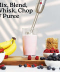 Heavy Duty 4 In 1 Immersion Blender With Whisk And Milk Frother 800W Hand Mixer blending a smoothie with fruits on the table.