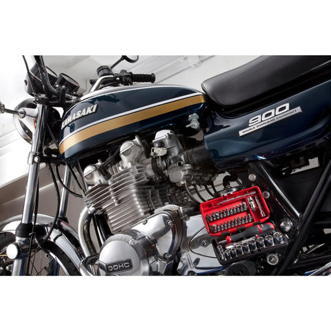 Motorcycle with attached One Quarter Inch Drive Socket Set, Six Point, Thirty Eight Piece Tool Kit for Mechanics, visible on frame.