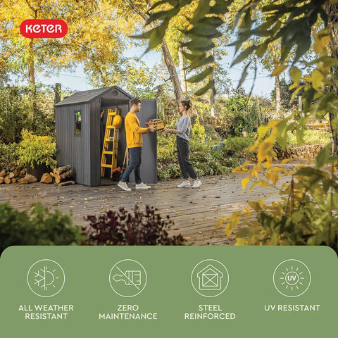 Lockable Resin Outdoor Storage Shed Graphite Gray Four By Six Feet in a garden, showing two people using it for organizing tools.