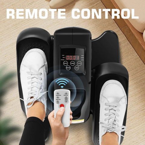 Under Desk Elliptical Machine With LCD Display Electric Seated Pedal Exerciser Portable Quiet Mini Elliptical For Home Use 2 In 1 Power And Manual Modes Compact Low Impact Leg Exerciser For Office Or Living Room Dark Black with remote control and user feet on pedals.