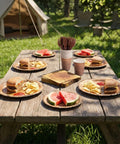 144 Pcs Disposable Rustic Wood Grain Slice Tableware Set for 24 Guests with plates, cups, and cutlery on picnic table outdoors.
