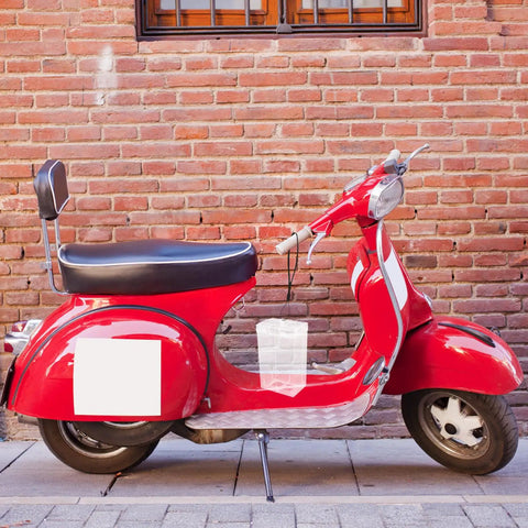 Durable Outdoor Waterproof Electrical Outlet Cover For Universal Charging Stations And Cord Storage Box on a vintage red scooter.