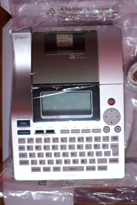 Pro Grade PT 2700 Desktop Labeling System With Huge Backlit 16 Character Display PC Connect Print Seven Lines In Eight Font Sizes And Twelve Styles Holds 99 Labels Portable Label Printer Silver Black showing keyboard and display.