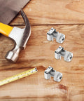 Hella Sturdy M6 Rack Mount Screw Kit With Cage Nuts For Server Cabinets and Equipment Racks, with hammer and tape measure on wood.