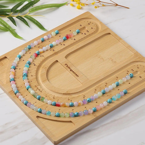 Bamboo Bead Board for Jewelry Making With 3 U Shaped Grooves And 4 Storage Slots For Necklace And Bracelet Beading DIY Jewelry Crafting Gear Supplies Kit, showcasing bead layout on a bamboo board.