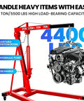Rock Solid Heavy Duty Two Ton 4400 Pounds Engine Hoist Cherry Picker with adjustable boom and hydraulic pump lifting engine.