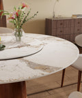 53 Inch Round Dining Table With Smooth Rotating Lazy Susan And Solid Hourglass Base Delivers A Clean Marble Look Top crafted with flowers and dishes