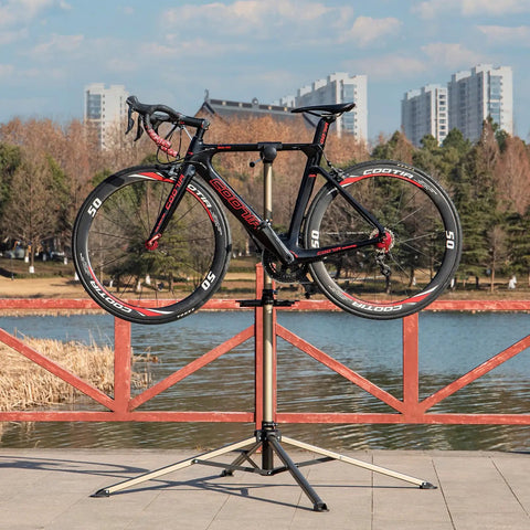 Heavy Duty Bike Repair Stand For Home Shop And Pro Mechanics Adjustable Bicycle Workstand holding road bike outside