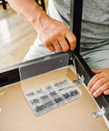 Man assembling furniture with Stainless Steel Shower Panel Screw Kit 400 Piece Assortment With Small Self Tapping Screws.