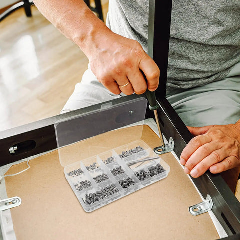 Man assembling furniture with Stainless Steel Shower Panel Screw Kit 400 Piece Assortment With Small Self Tapping Screws.