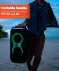 Person carrying Portable Party Speaker With Foldable Handle And Pro Sound, Club 120 Delivers Dope Bass on beach at dusk