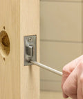 Privacy Door Lock With Lever Handle For Commercial Interiors Brushed Chrome Finish being installed on wooden door