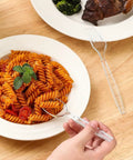 Person using disposable fork from 400 Count Heavy Duty Plastic Utensils Set Disposable Forks And Spoons Party Ready Cutlery For Big Gatherings Crack Resistant And BPA Free Food Grade Silverware For Events Durable Budget Friendly set with plate of pasta