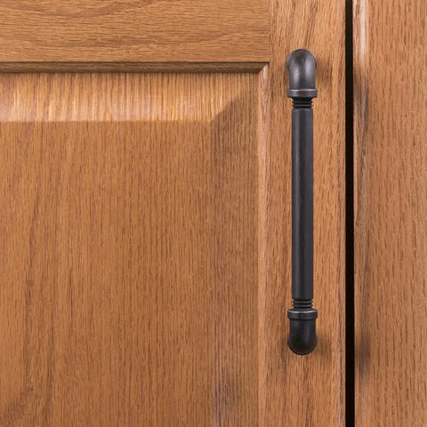 Vintage Bronze Kitchen Cabinet Pulls on wooden cupboard, showing rustic style and heavy-duty design for storage.