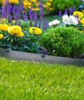 Garden with flowers secured by terrace boards using 40 Pack Landscape Anchoring Stakes 10 Inch Garden Stakes For Terrace Boards Weed Fabric And Inflatable Decor Fixing Heavy Duty ABS Outdoor Stakes Built To Last For Quick Setup And Strong Stability In Any Yard.