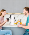 Couple enjoying drinks with Thermal Coffee Carafe 74oz Stainless Steel Vacuum Insulated Water Jug For Hot Or Cold Beverages on counter