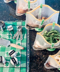 Upgrade Your Kitchen Grind With This Adjustable Ziplock Bag Holder Stand Featuring A Nonslip Base For Effortless Freezer Storage Hands Free Countertop Mount Keeps Plastic Bags Locked Down Straight Up In A Clean Green Set Of Four with filled bags and kitchen tools.
