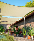 Beige 7 Ft By 7 Ft Shade Sail Outdoor Canopy With UV Block 95 Percent UPF50 Sun Protection installed over patio with plants