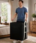Extra Large Black Storage Bins With Heavy Duty Zipper, Foldable Fabric Bags For Clothes Blankets Comforters Pillows And Toys being lifted by a smiling man.