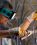 Rock Solid Auto Darkening Welding Goggles With Flip Up Lens Solar Powered For Instant Shade Change and Hassle Free MIG TIG Plus Gas Cutting Coverage You Will Appreciate Back At The Shop worn by welder using MIG technique.