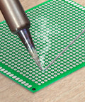 Soldering on a Double Sided PCB Board Prototype Kit For DIY Soldering With 32 Pieces In Five Sizes