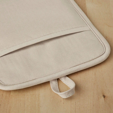 Close-up view of a Ribbed Soft Silicone Pot Holder 2 Pack Set Hella Heat Resistant To 500F Milkshake Tan with hanging loop.