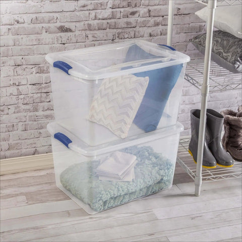 Heavy Duty SixtySix Quart Clear Plastic Storage Bins Two Pack With Blue Latch Lids showing stacked bins with pillows and blankets inside.