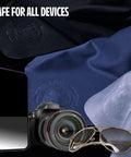 Cellhelmet See Lion Swipes microfiber cloths, black and navy, 2-pack, shown with phone, camera, and glasses.