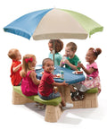Children seated at Naturally Playful Kids Picnic Table With Removable Umbrella For Indoor And Outdoor Use, blue and green