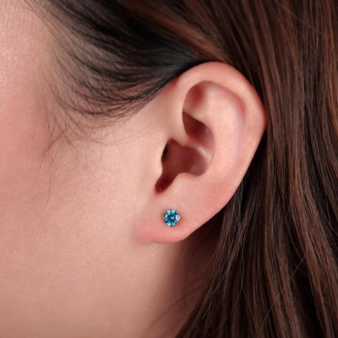 Skip The Itch With These Implant Grade G23 Titanium Screw Back Earrings Featuring Hypoallergenic Design And F136 Certified For Totally Sensitive Tolerant Ears While Delivering Premium Nickel Free Security And Long Lasting Wear Without Any Drama Or Redness, showcasing aqua CZ stone on ear.