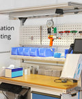 Workstation with tools and storage boxes mounted on pegboard, showcasing ergonomic setup and organized workspace.