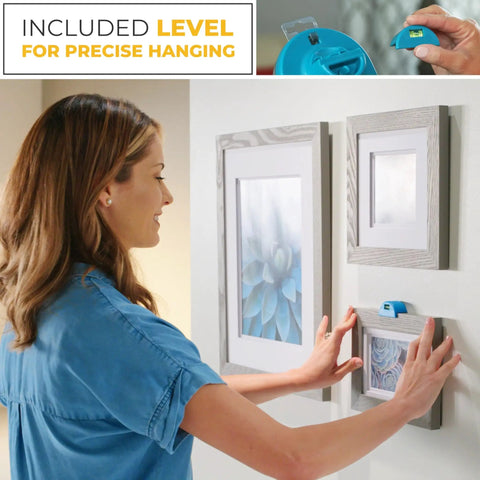 Woman using All In One Picture Hanging Kit With Level Tool And Sawtooth And Wire Hangers, Wall Mount Kit In Durable Hardware Case, 85 Piece Hanging Essentials For Quick Precise Picture Hanging And Leveling to hang frames on a wall.