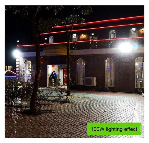 Top Shelf Solar Floodlights Featuring No Sweat Dusk To Dawn Sensor And Weatherproof Remote Control For Badass Garden And Street Lighting Delivering Slick All Night Illumination illuminating a pathway and building entrance at night.