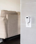 Smooth Operator Indoor Plug In Digital Timer With Two Grounded Outlets And Sunsmart Sunrise Sunset Tracking For Zero Hassle Weekly Scheduling Slick White Build mounted on wall near beige sofa.
