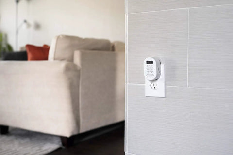 Smooth Operator Indoor Plug In Digital Timer With Two Grounded Outlets And Sunsmart Sunrise Sunset Tracking For Zero Hassle Weekly Scheduling Slick White Build mounted on wall near beige sofa.