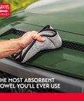 Person using Terry Weave Microfiber Towel for Super Fast Drying and Scratch Free Car Detailing on green car hood, 16 by 16 inch.