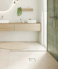Square Tileable Shower Drain Set With Brushed Stainless Steel Construction And Flush Floor Mount Design For Modern Bathrooms featuring clean, modern bathroom with tiled shower and minimalist decor.