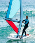 Inflatable Windsurfing Wing Foil Kit For Easy Wind Foiling Handheld Wing Foil Board For Surfing And Water Play Stable 2.2 Square Meters Wing Size Blue on the water with surfer.