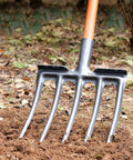 Beefy Garden Digging Fork For Hard Ground, heavy-duty 4-tine spading tool in use, high carbon steel, anti-breakage design