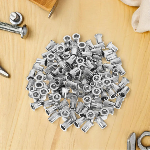 Stainless Steel Flat Head Knurled Rivet Nuts Kit 1/4-20 Thread Rivet Nut Inserts, 120 Pcs on wooden surface
