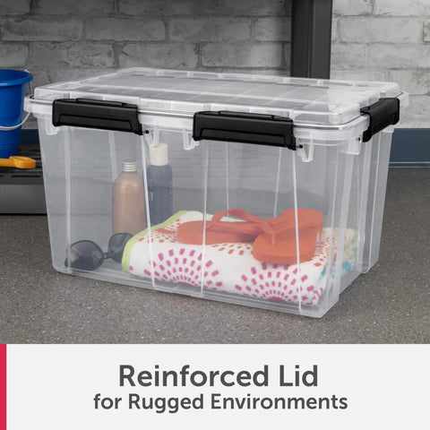 54 Quart Tough As Nails Crystal Clear Storage Tote With IP68 Rated Gasket Sealed Lid And Heavy Duty Secure Latches full of items on a workspace.