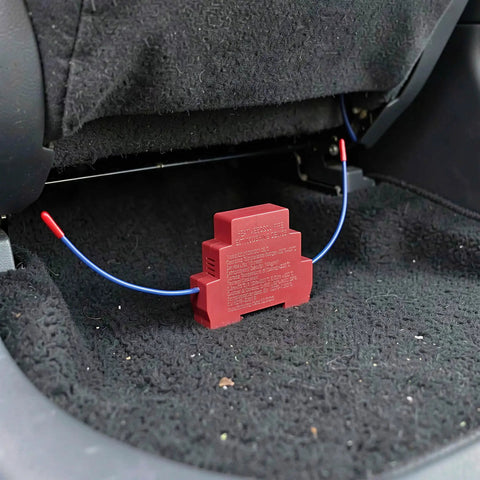 Top Tier Auto Fire Suppressor Dual Nozzle Kit For Electric Panels And Battery Bays Heat Triggered 2 Pack installed in vehicle floor.