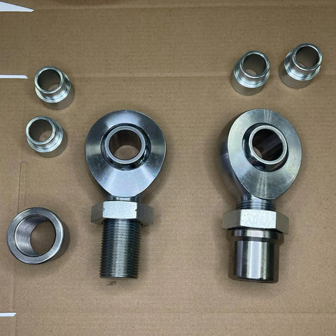 Badass 1.25 Inch Chromoly Rod End Heim Joint Kit With Heat Treated Bearings and Hard Chrome Finish on brown background.
