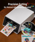 All In One Color Sticker Printer And Cutter For DIY Crafters And Custom Labels And Gifts With Thermal Dye Sublimation 300 DPI And Precise AI Auto Cutting device printing stickers on a table.