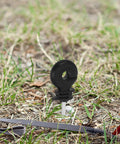 Screw-In Wire Insulators For Wood Posts Sun Resistant 51 Pack With Socket Tool, Tough As Nails Electric Fence Clips For Cattle Fencing, Rainproof And High Holding Power For Large Farms on grass